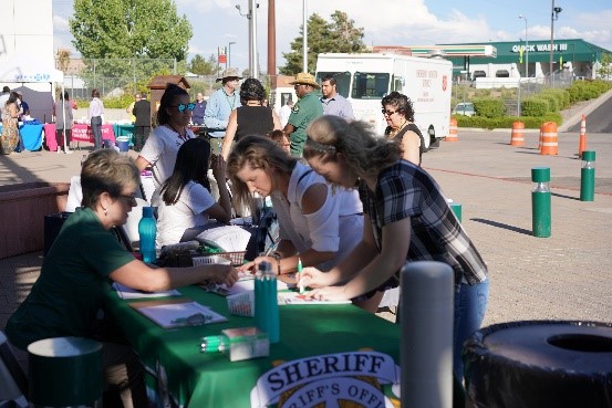 photo of community members filling out forms at a Washoe Sheriff booth